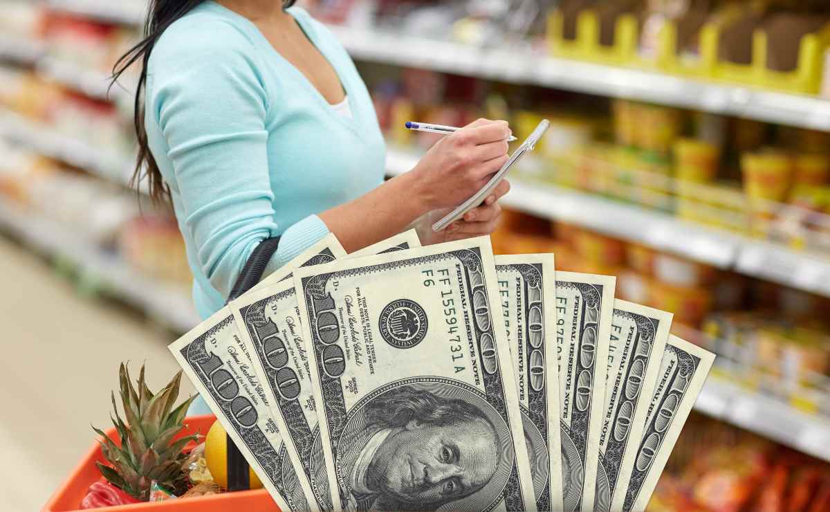 Woman grocery shopping and dollars to talk about changes in the Food Stamps program that affect SNAP beneficiaries
