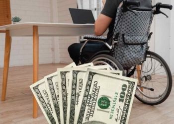 PErson with a disability and dollars because disability benefits will soon arrive for thousands of beneficiaries in the USA