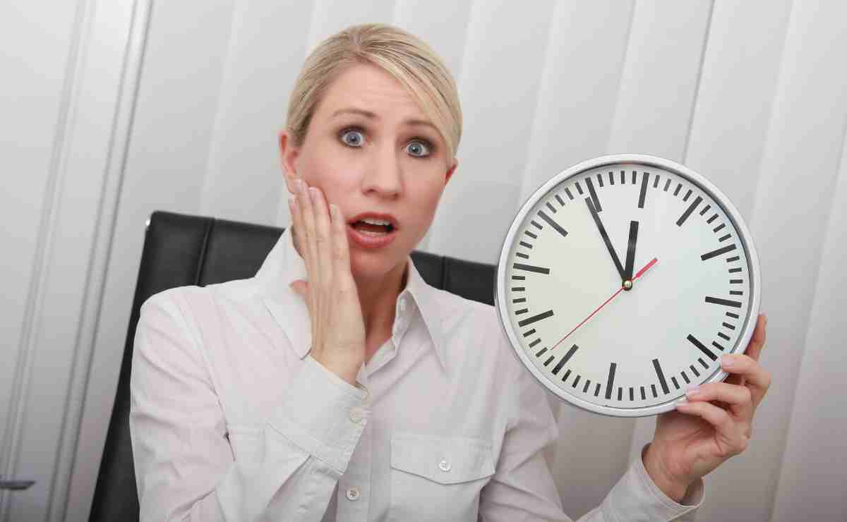 Woman with clock so don't panic because there is something you can do to increase your Social Security benefits if you are still working