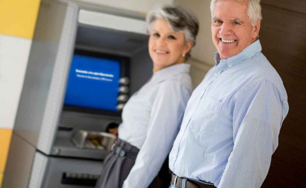 Retirees at an ATM since eligible seniors will cash a new payment from Social Security