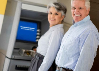 Retirees at an ATM since eligible seniors will cash a new payment from Social Security