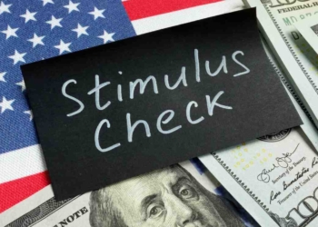 Sign with stimulus check, dollars and US flag to deal with payments of $3,284 from stimulus checks in Alaska coming soon