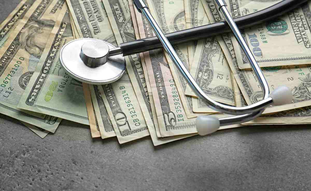 Dollars and stethoscope to talk about SSDI disability benefits are about to reach recipients bank accounts