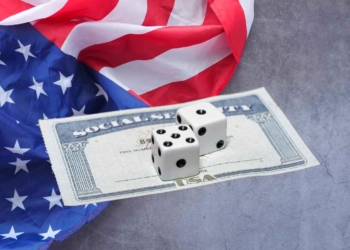 Dice on SSA card and U.S. flag to talk about Social Security and overpayments