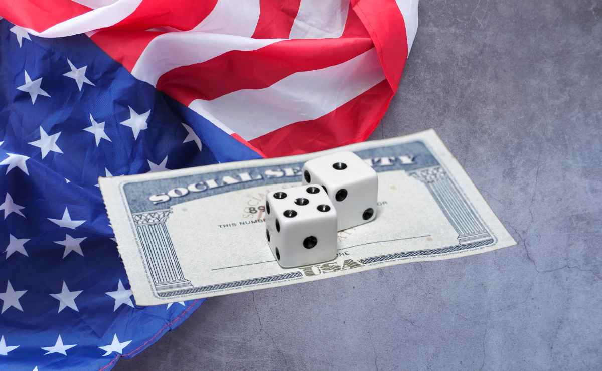 Dice on SSA card and U.S. flag to talk about Social Security and overpayments