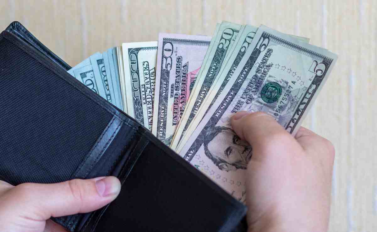 Wallet full of dollars to talk about Stimulus checks to fight inflation and soaring prices