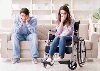 woman with disability and man on a sofa sad to talk about disability benefits claims can take too long