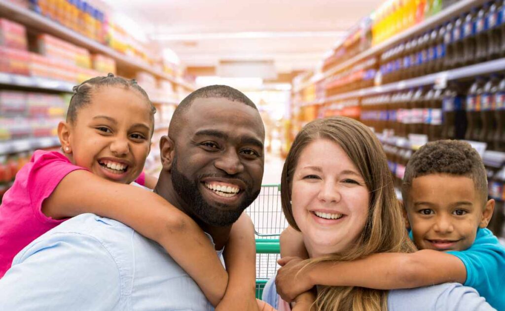 Family with kids in a store and dollars to talk about SNAP benefits and income limits for American families