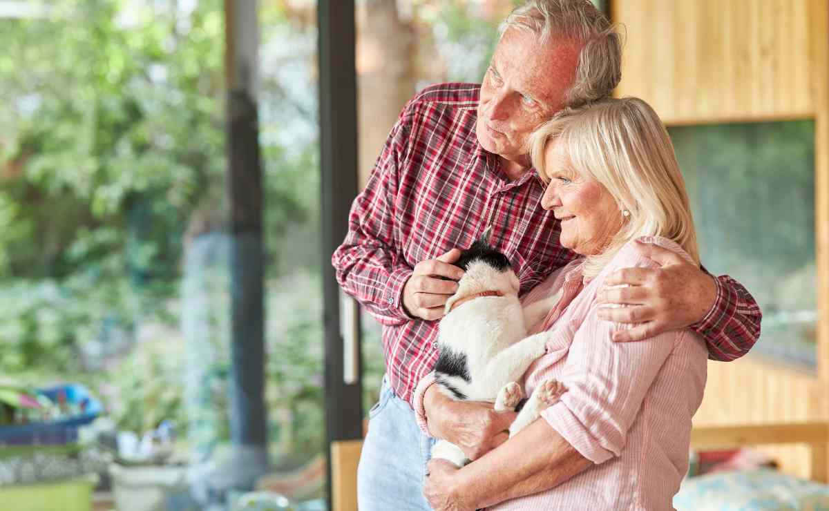 Senior man and woman with dog to talk about SSI maximum amounts for couples is $1,371 in 2023
