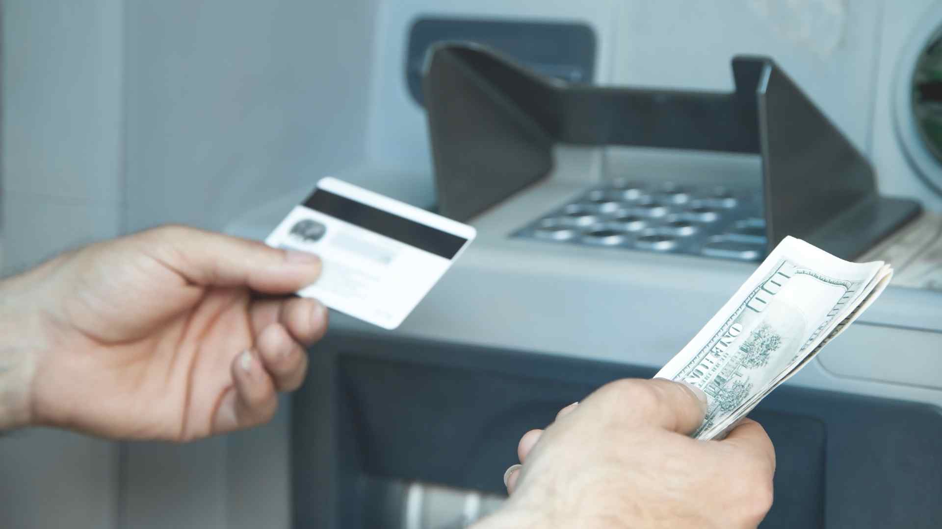 Person at ATM with dollars for Social Security payments for 62-year-olds and older, get a check in the United States