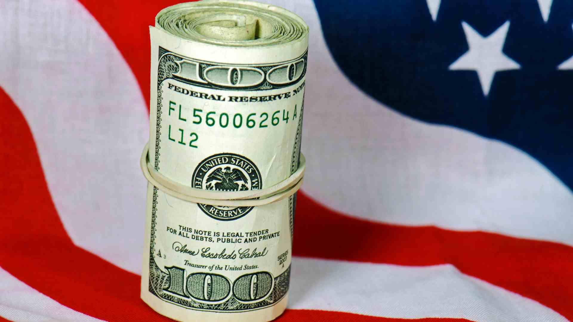 Dollars and US flag for Stimulus checks in the United States, some payments will be due in just a few days